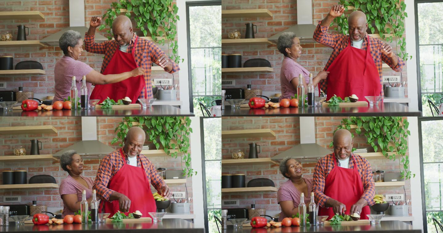 快乐的非裔美国老夫妇在厨房里一起做饭