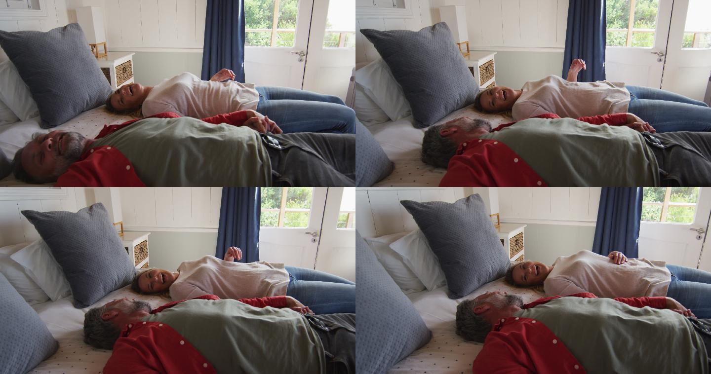 幸福的高加索成熟夫妇躺在酒店房间的床上