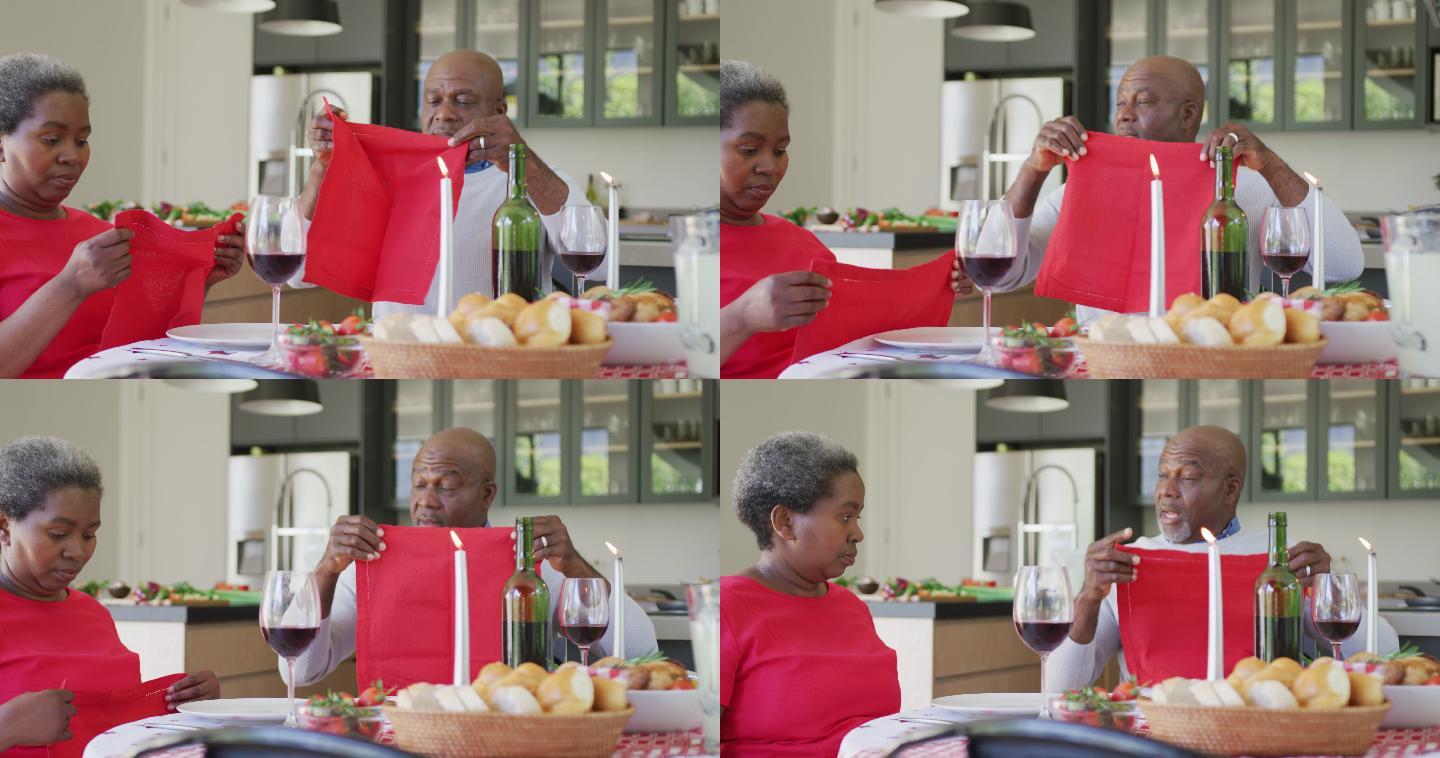 快乐的非裔美国老年夫妇在厨房一起吃饭