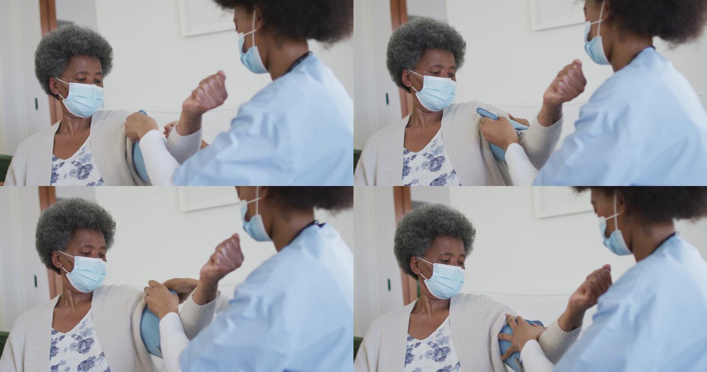 非裔美国女医生和戴口罩的老年女病人