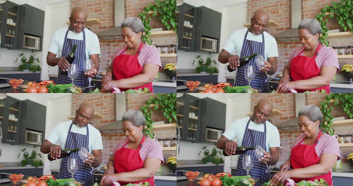 快乐的非裔美国老夫妇一起做饭，在厨房喝葡萄藤