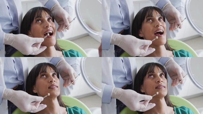 男牙医在现代牙科诊所检查女病人的牙齿