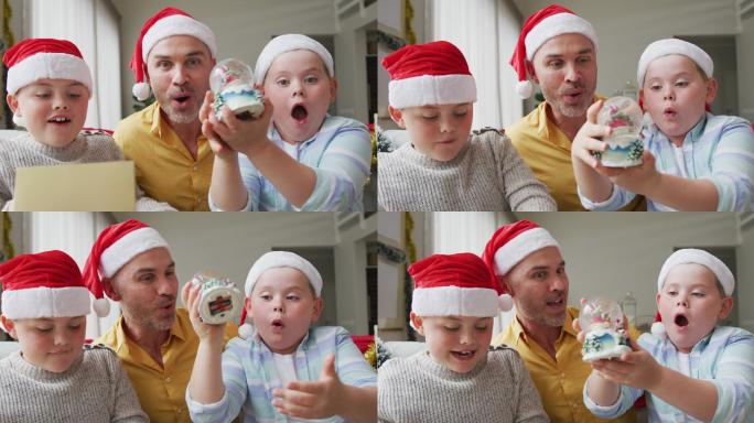 白人父亲和两个儿子戴着圣诞帽，拿着雪花玻璃球坐在家里的沙发上