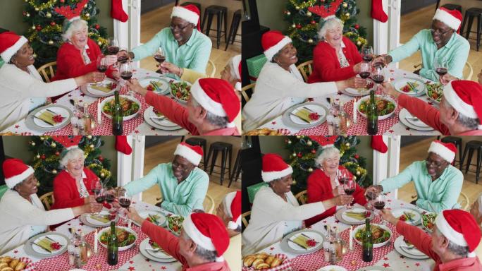 快乐的一群不同的老年朋友在圣诞期间庆祝大餐和喝葡萄藤