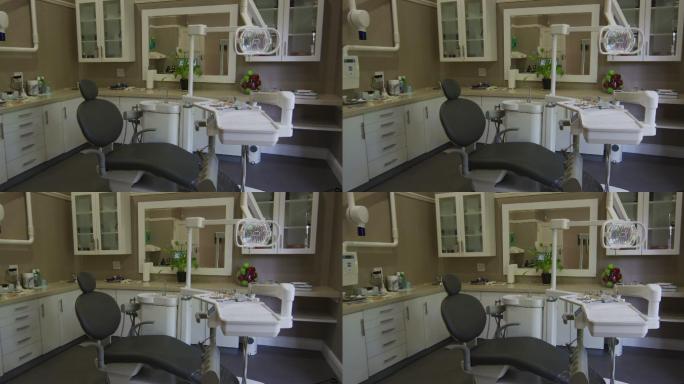 空荡荡的牙科诊所内部有黑色的牙科椅和工具