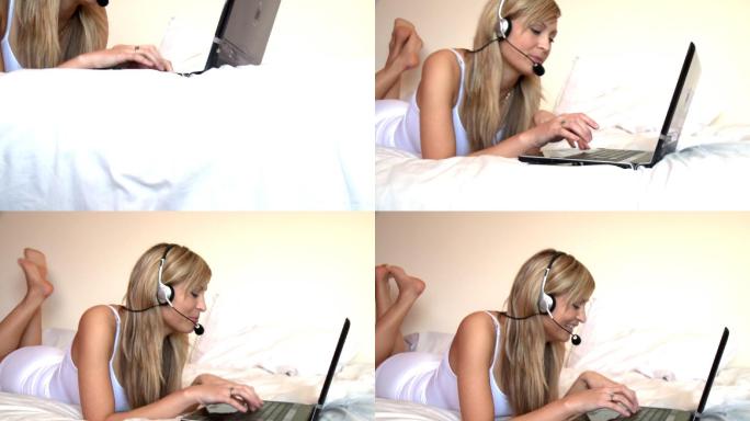 女人躺在床上看电脑戴耳机特写