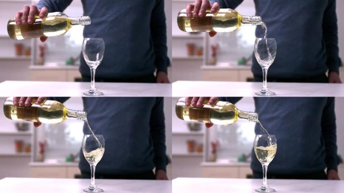 一名男子将白葡萄酒倒入玻璃杯中的慢动作