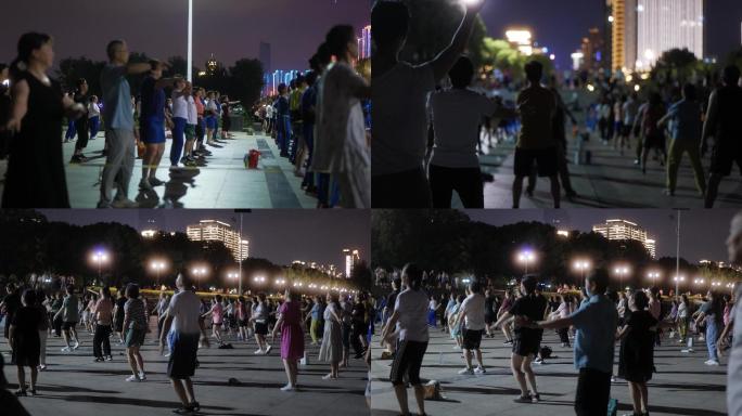 夏天夜晚江边跳广场舞的人群