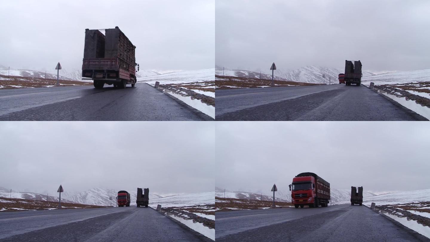 高原雪山下大货车长途运输