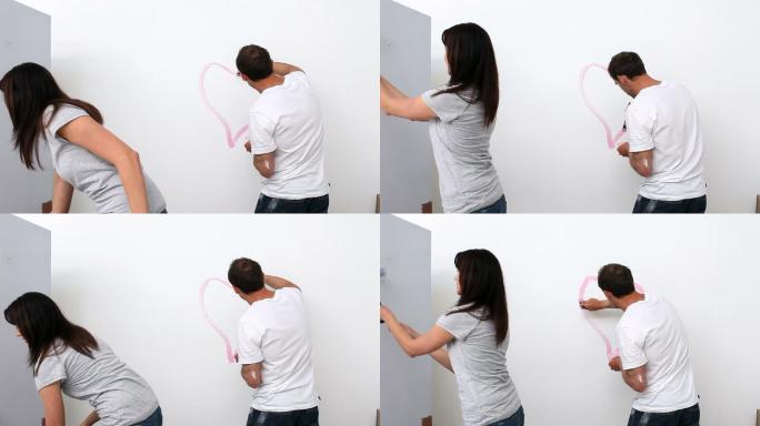 丈夫在墙上画了一颗心特写