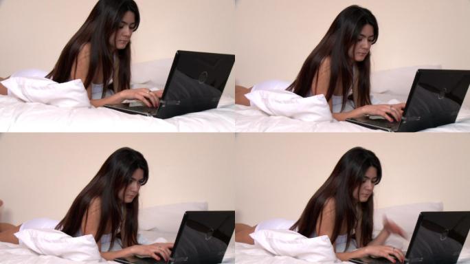 女人躺在床上看电脑特写