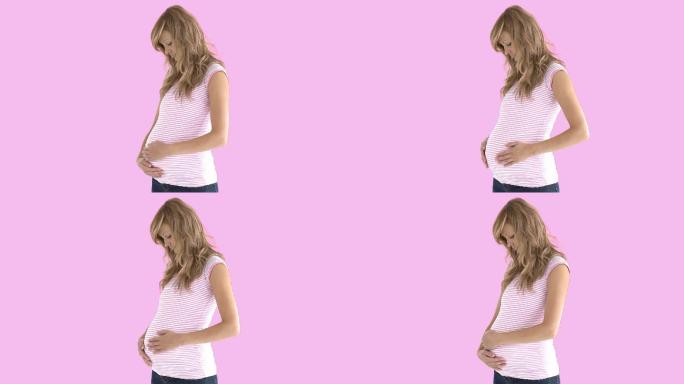 孕妇抚摸自己的肚子特写