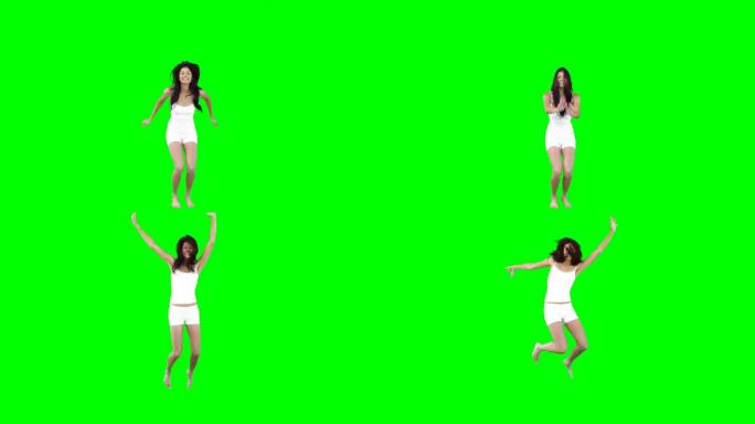 一个亚洲女性四肢伸展跳跃慢镜头，在绿色背景下