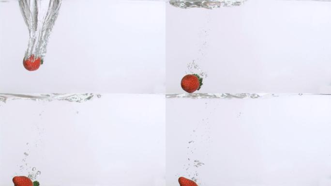 一个草莓在白色背景下以超慢的动作落在水中