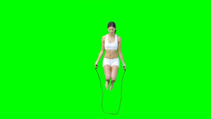 一个亚洲女性跳绳慢镜头，在绿色背景下