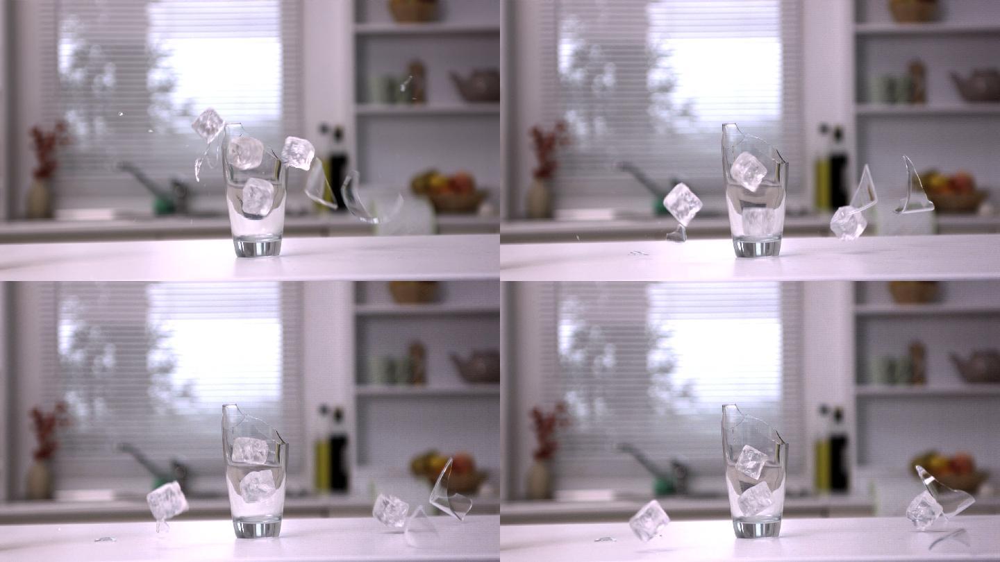 在慢镜头中，冰块坠落并打碎玻璃杯