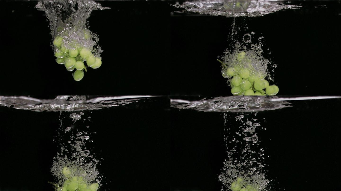 在白色的背景下，葡萄在水中以超慢的动作落下