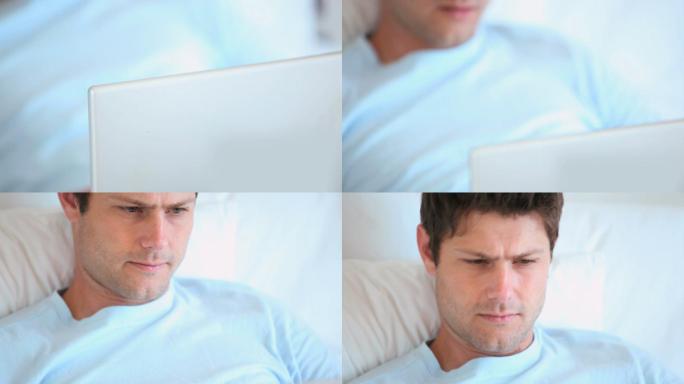 一名男子躺着用笔记本电脑搜索一个网站