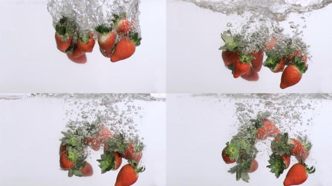 多个草莓落在水中慢镜头