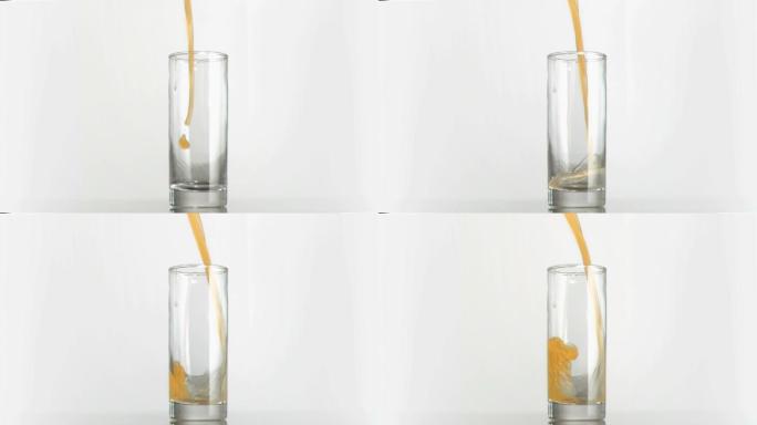 橙汁以超慢的动作倒在白色背景的玻璃杯里
