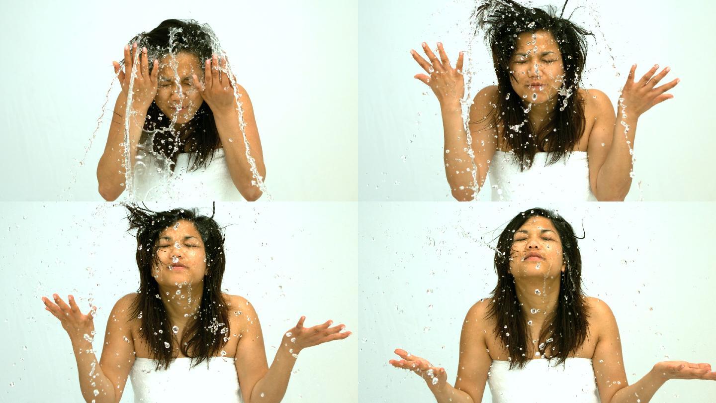 在慢镜头中，一个女人往脸上泼水