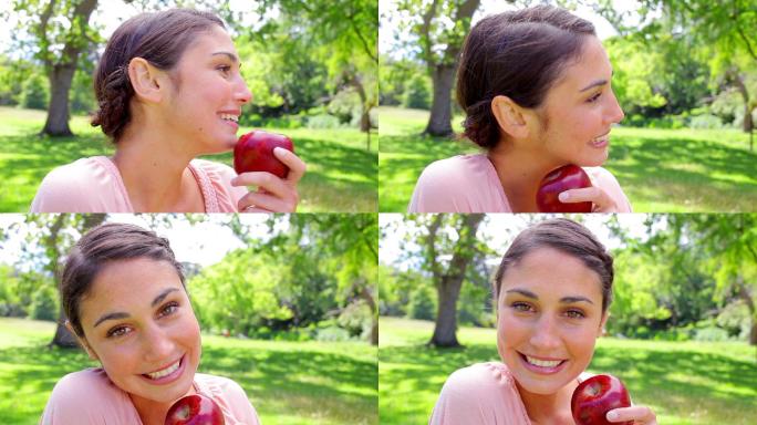 一个西方女性拿着红苹果