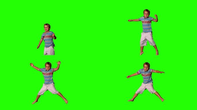 男孩在绿色屏幕上跳的慢动作