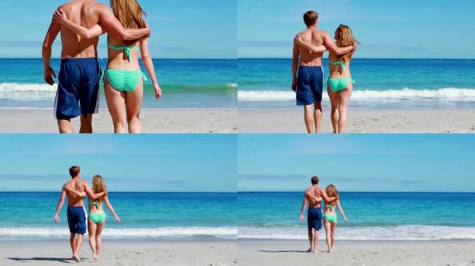 一对幸福的情侣一起在海滩上散步