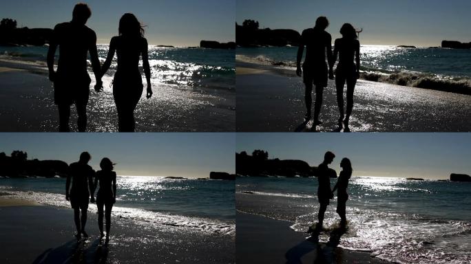 放松的情侣站在月光下的海滩上