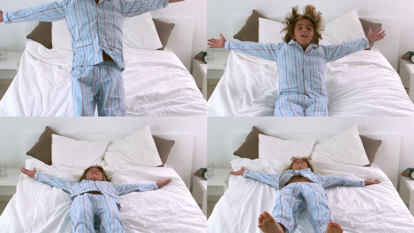 穿着睡衣的小男孩跳回床上的慢动作