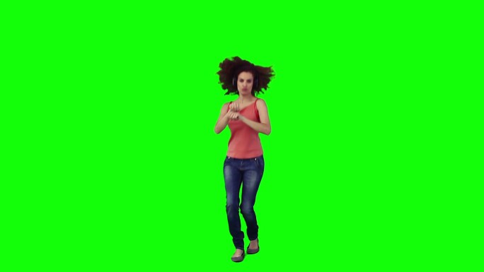 一个非洲女性听音乐跳舞，在绿色背景下