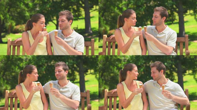 年轻的情侣们在公园的长椅上吃冰淇淋