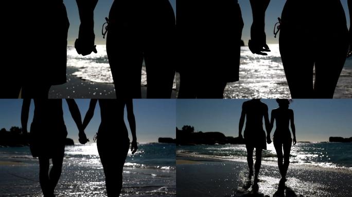 一对情侣在月光下漫步在沙滩上