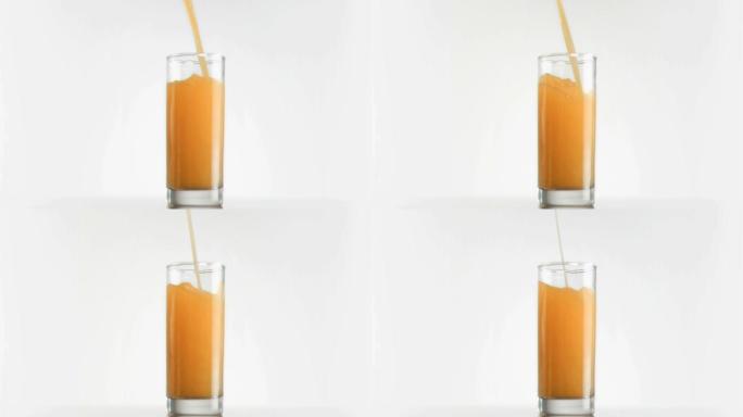 用超级慢镜头将芒果汁倒入白色背景的玻璃杯中