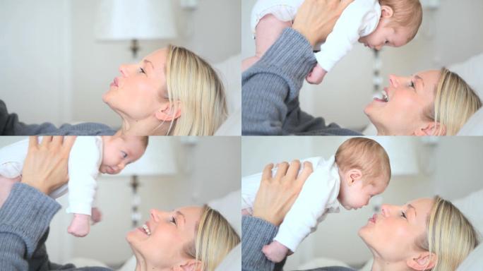 一位躺在床上的妇女把一个婴儿靠近她的脸，然后亲吻他的脸颊