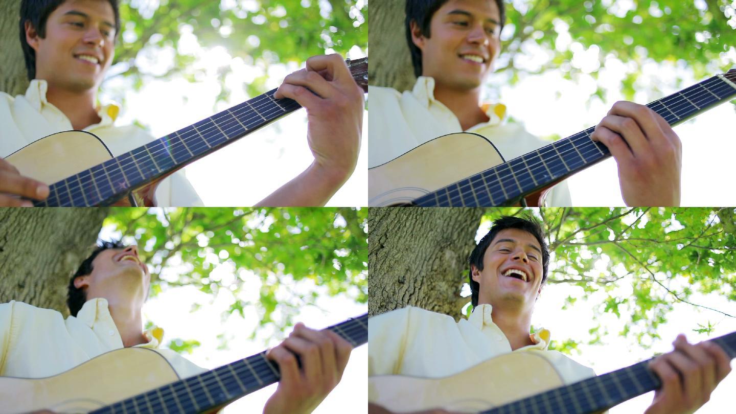 一个快乐的人在公园里弹吉他