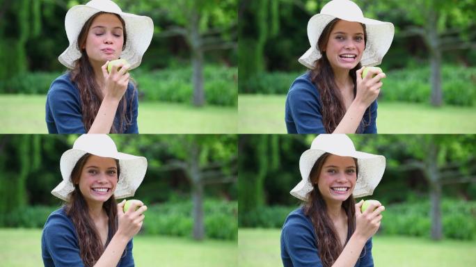 一个白人女性吃苹果