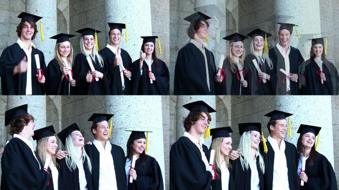 五个身着毕业礼服的青年做手势
