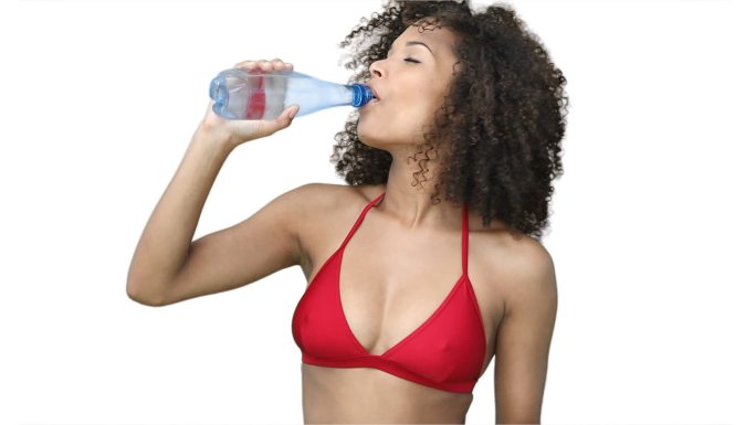 女人在一个白色背景的红色比基尼饮水