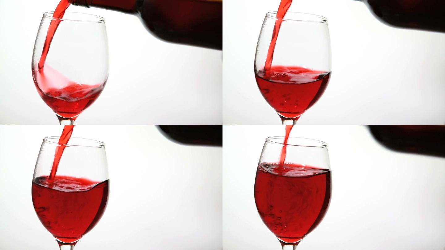 白色表面上盛满红酒的玻璃杯