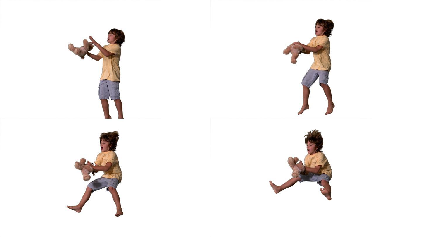 一个白人男孩跳跃接毛绒玩具慢镜头，在白色背景下