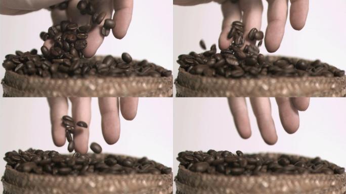 手抓咖啡豆在白色背景下慢镜头