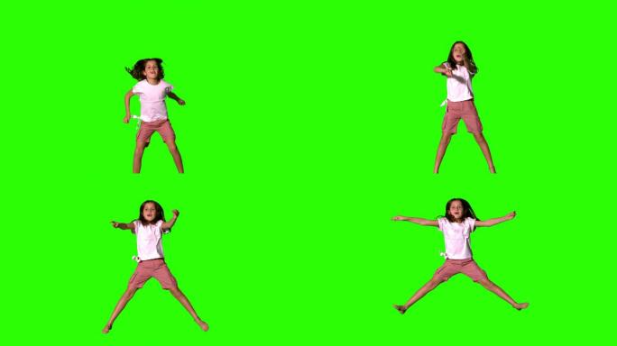 女孩在绿色屏幕上跳上跳下的慢动作