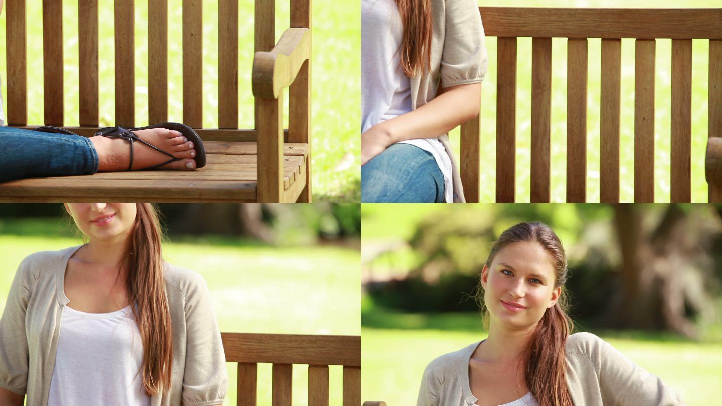 微笑的年轻女子坐在公园的长椅上