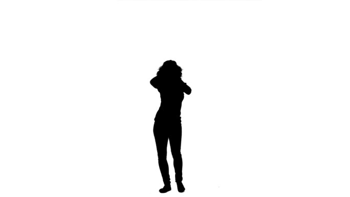 一个女人的剪影在白色的背景下移动和跳舞