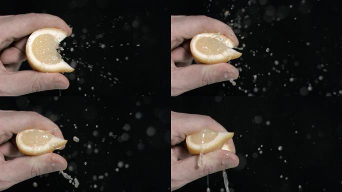 柠檬在超级慢镜头被挤在一个黑色的背景
