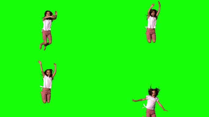 快乐的女孩跳跃在绿色屏幕的慢动作