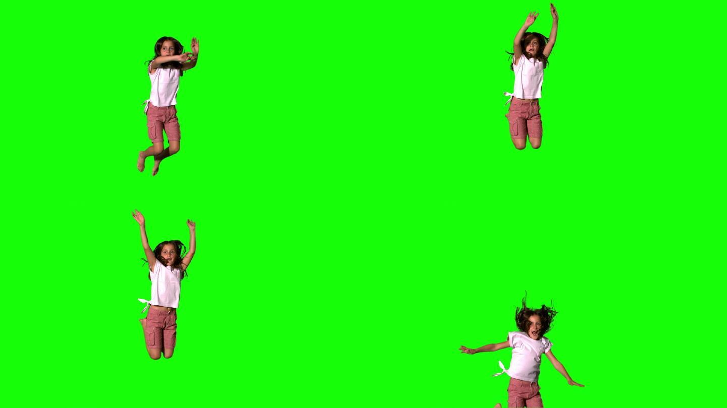 快乐的女孩跳跃在绿色屏幕的慢动作