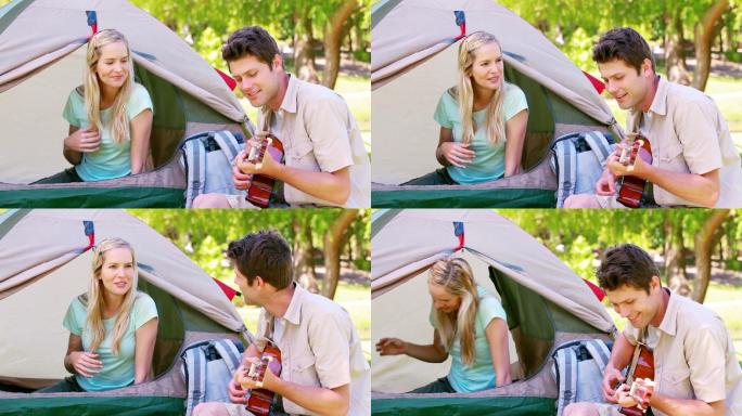一个男人在公园里给他的妻子弹吉他