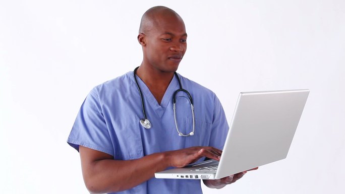 一个黑人男护士拿着笔记本电脑，在白色背景下